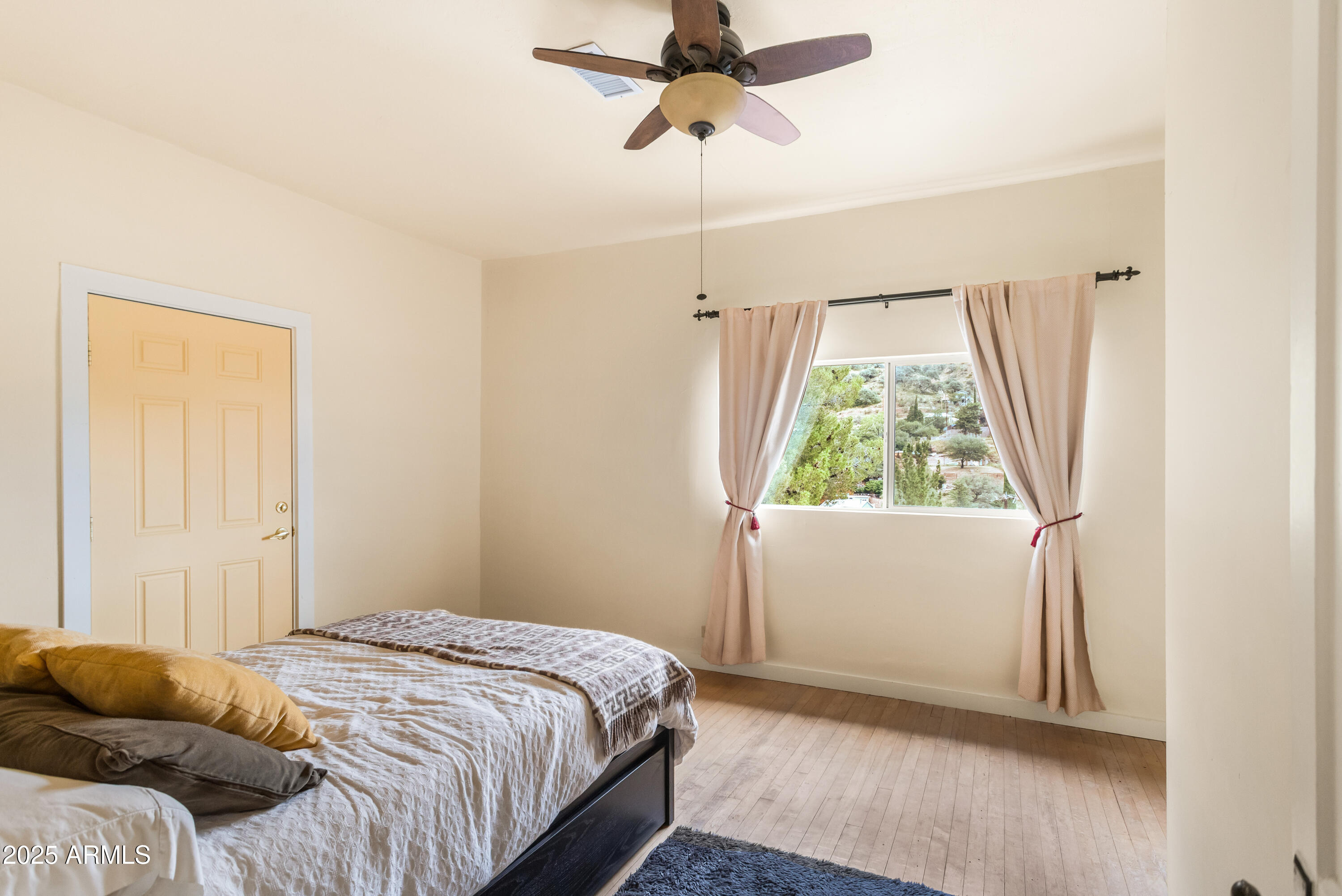 428 Brophy Avenue, Unit D Bisbee, AZ 85603 - Photo 28 of 40 a bedroom with a bed and a window