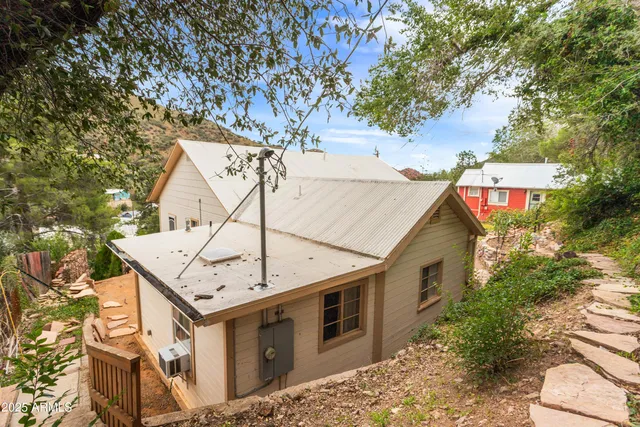 a view of a house with a tree in the background