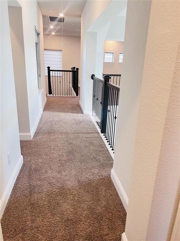 6825 Entwistle Road Frisco, TX 75034 - Photo 25 of 33 a view of a hallway with wooden floor and staircase