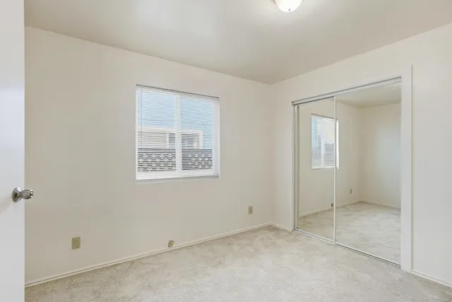 a kitchen with granite countertop a refrigerator and a sink