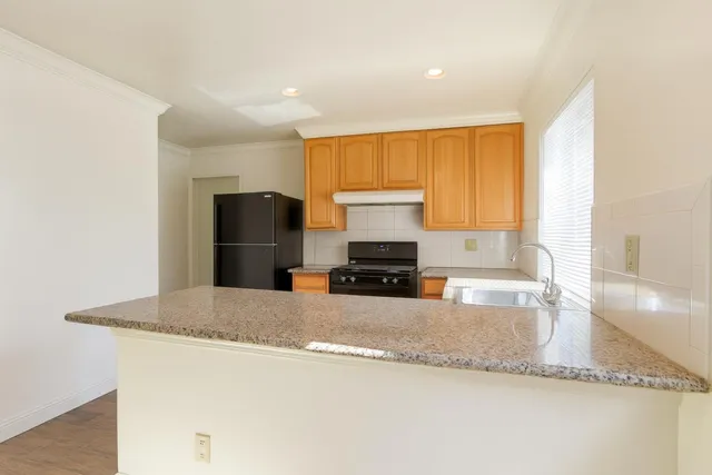 a kitchen with stainless steel appliances a stove sink and cabinets