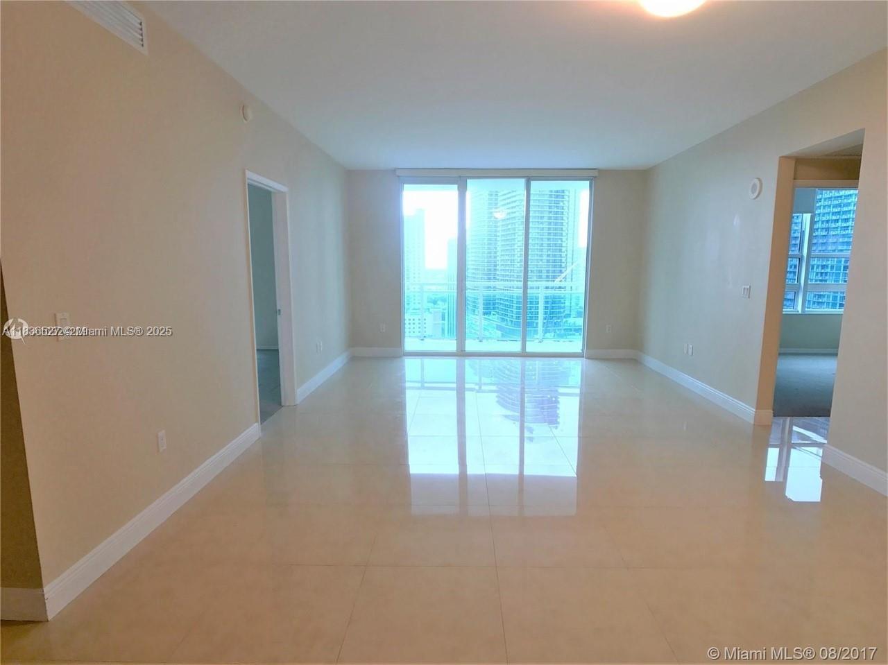 951 Brickell Avenue, Unit 2405 Miami, FL 33131 - Photo 14 of 38 a view of an empty room with glass door