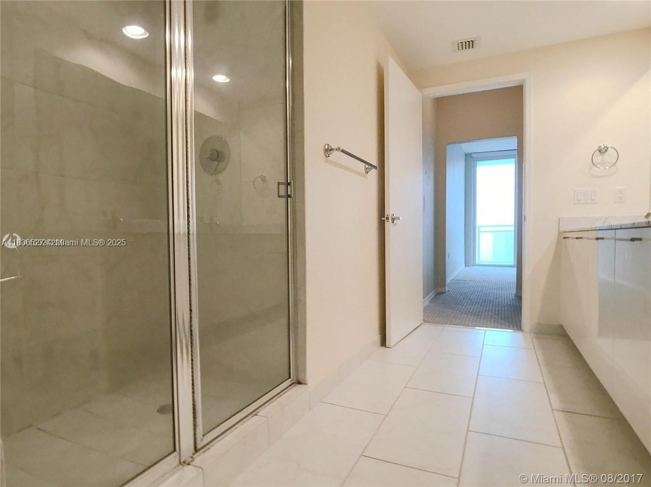 951 Brickell Avenue, Unit 2405 Miami, FL 33131 - Photo 24 of 38 a bathroom with a shower and a mirror