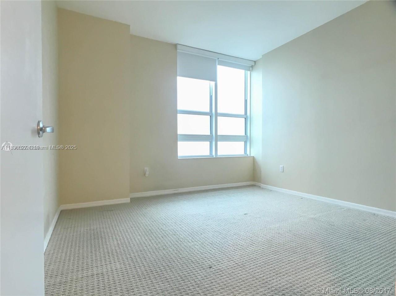 951 Brickell Avenue, Unit 2405 Miami, FL 33131 - Photo 25 of 38 an empty room with a window