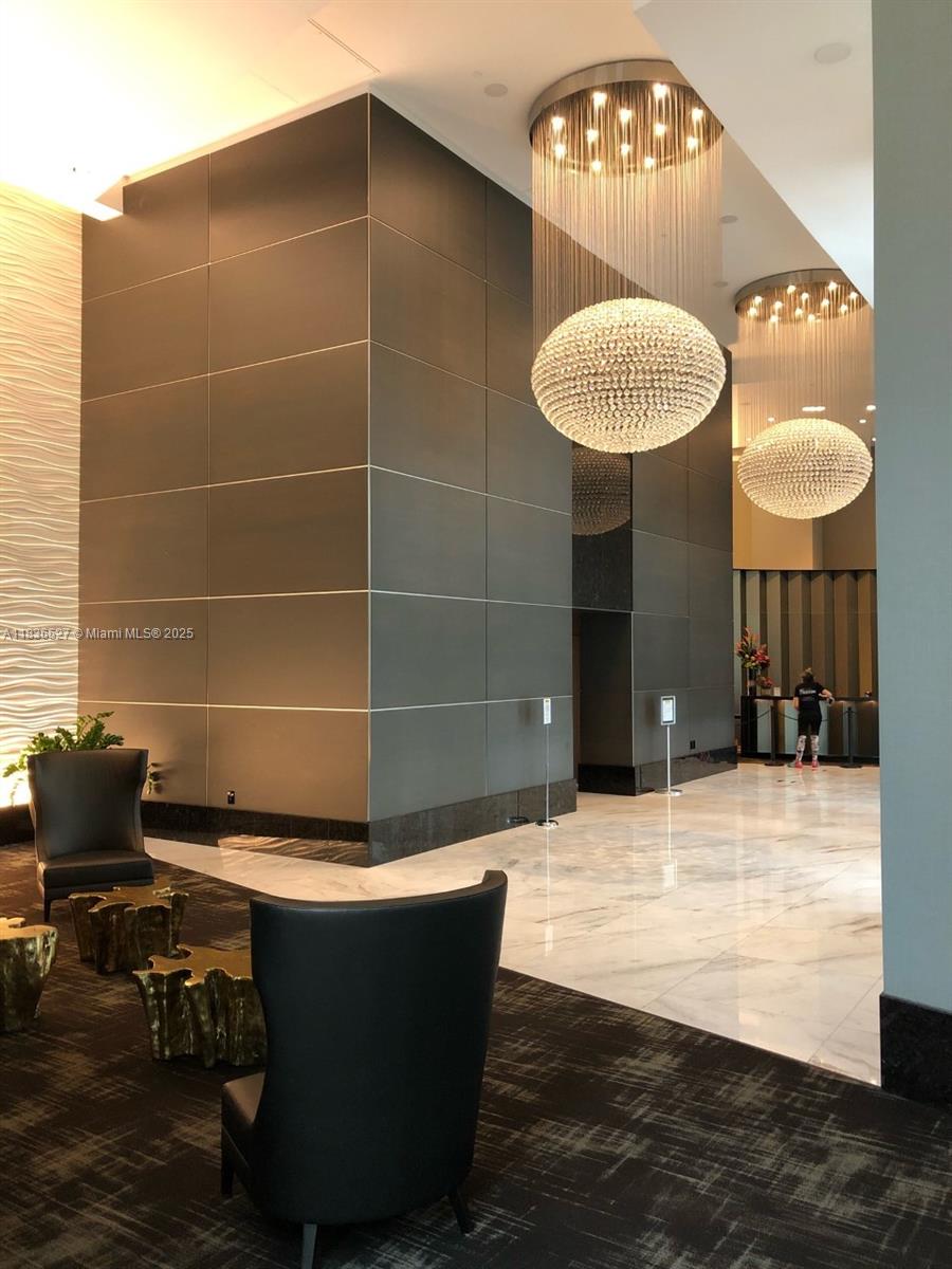 951 Brickell Avenue, Unit 2405 Miami, FL 33131 - Photo 29 of 38 a room with table and chairs