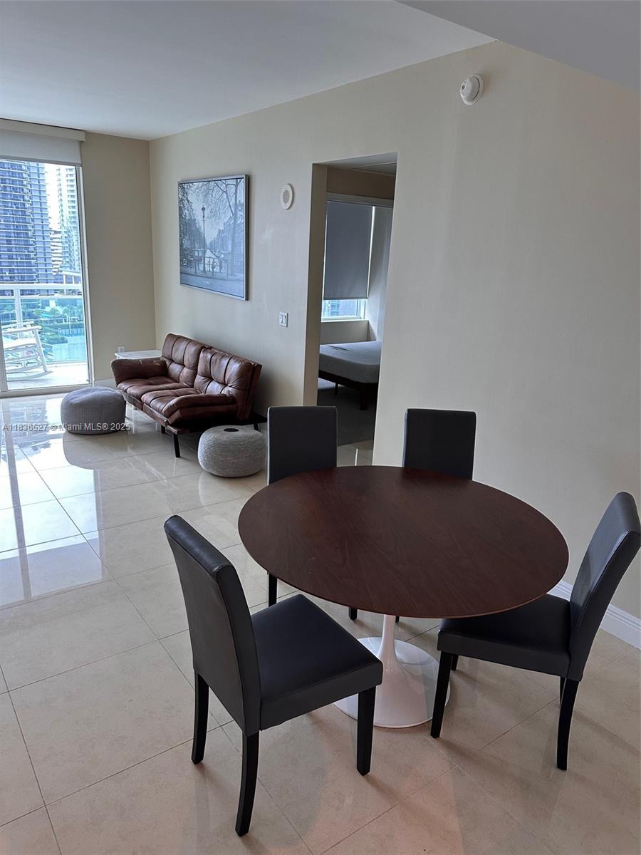 951 Brickell Avenue, Unit 2405 Miami, FL 33131 - Photo 5 of 38 a living room with furniture a rug and a window