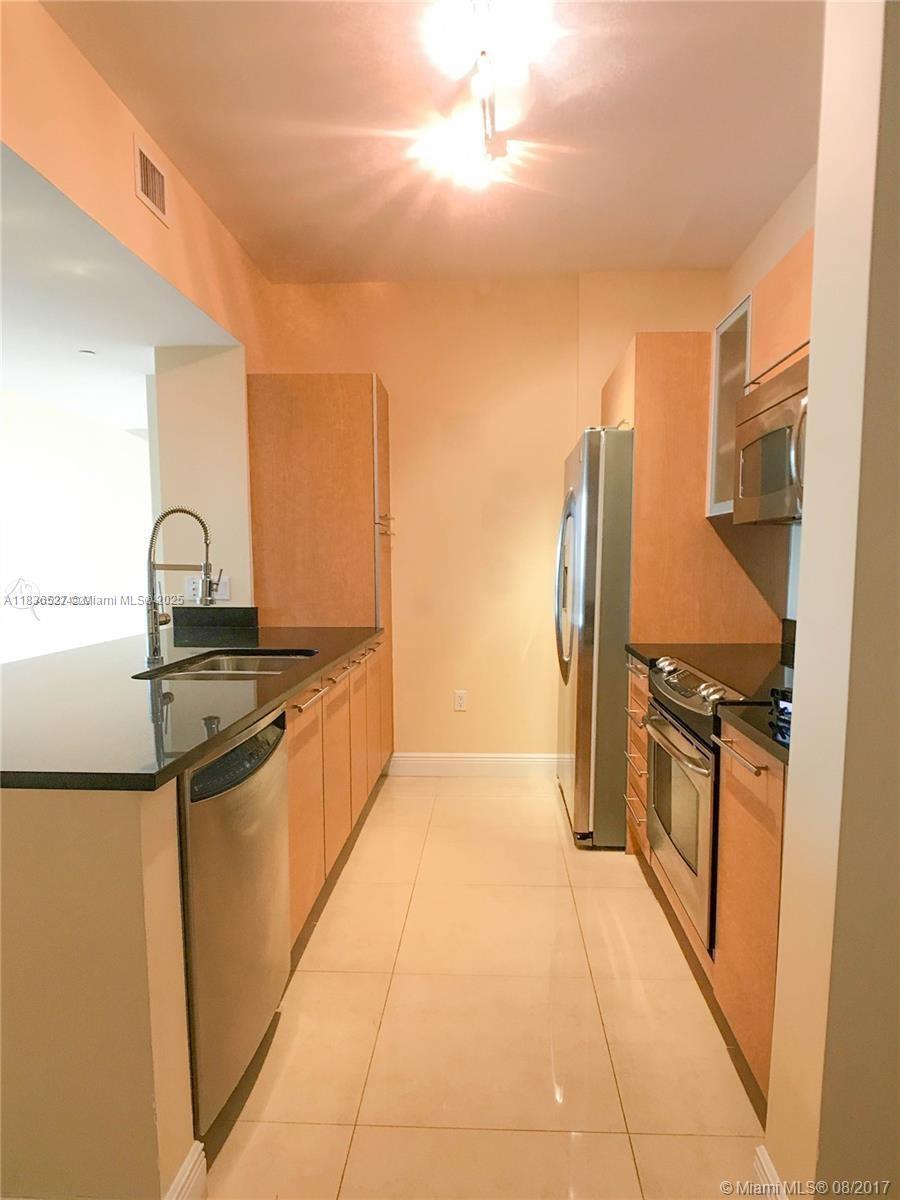 951 Brickell Avenue, Unit 2405 Miami, FL 33131 - Photo 9 of 38 a kitchen with stainless steel appliances granite countertop a refrigerator and a stove
