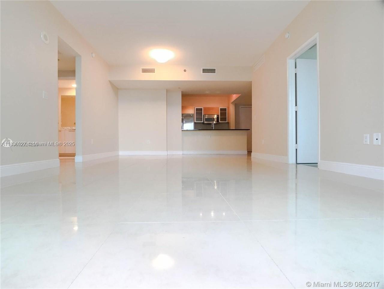 951 Brickell Avenue, Unit 2405 Miami, FL 33131 - Photo 10 of 38 a view of a hallway with a refrigerator