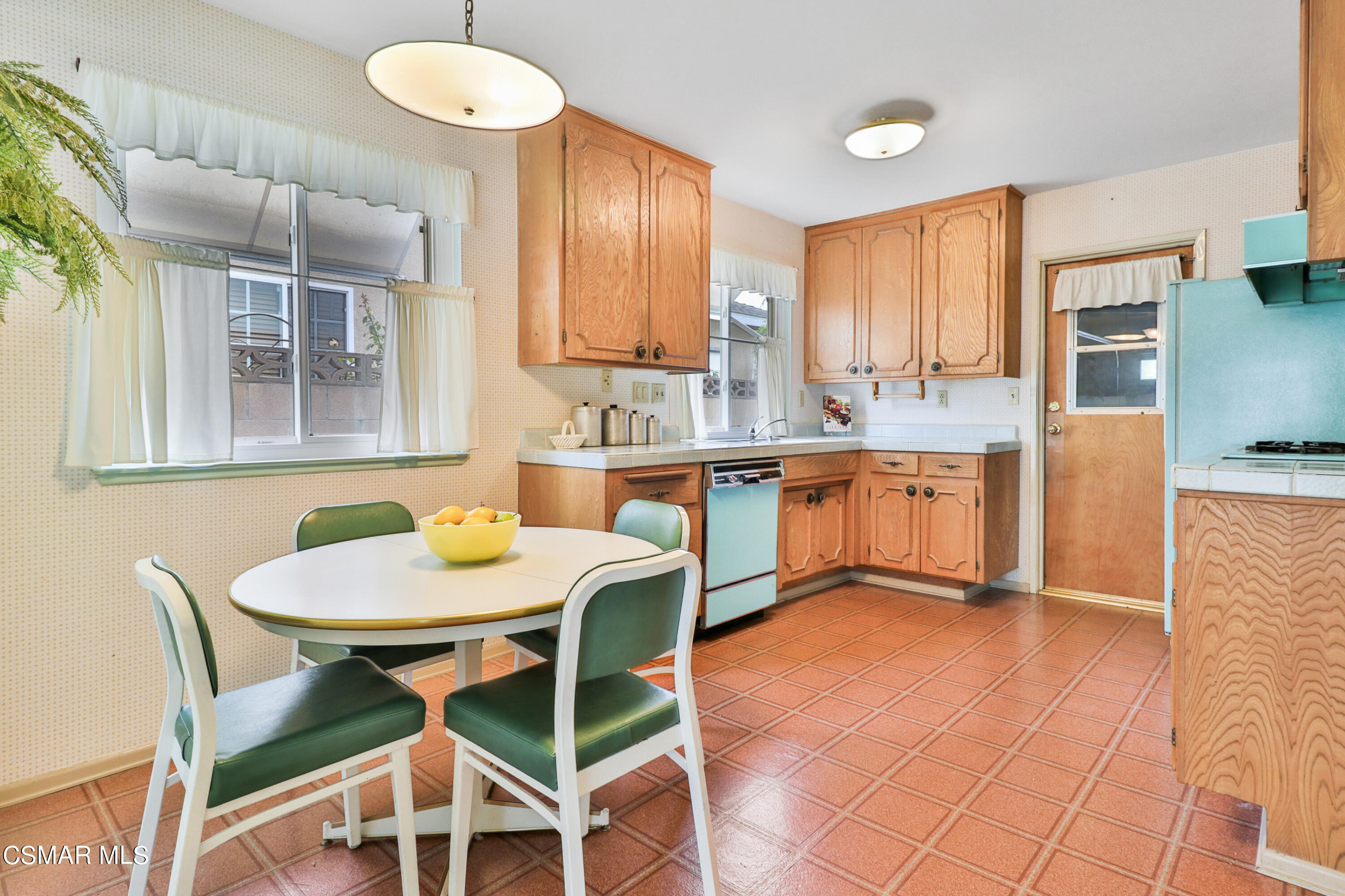1567 Fitzgerald Road Simi Valley, CA 93065 - Photo 5 of 25 a kitchen with a dining table chairs and white cabinets