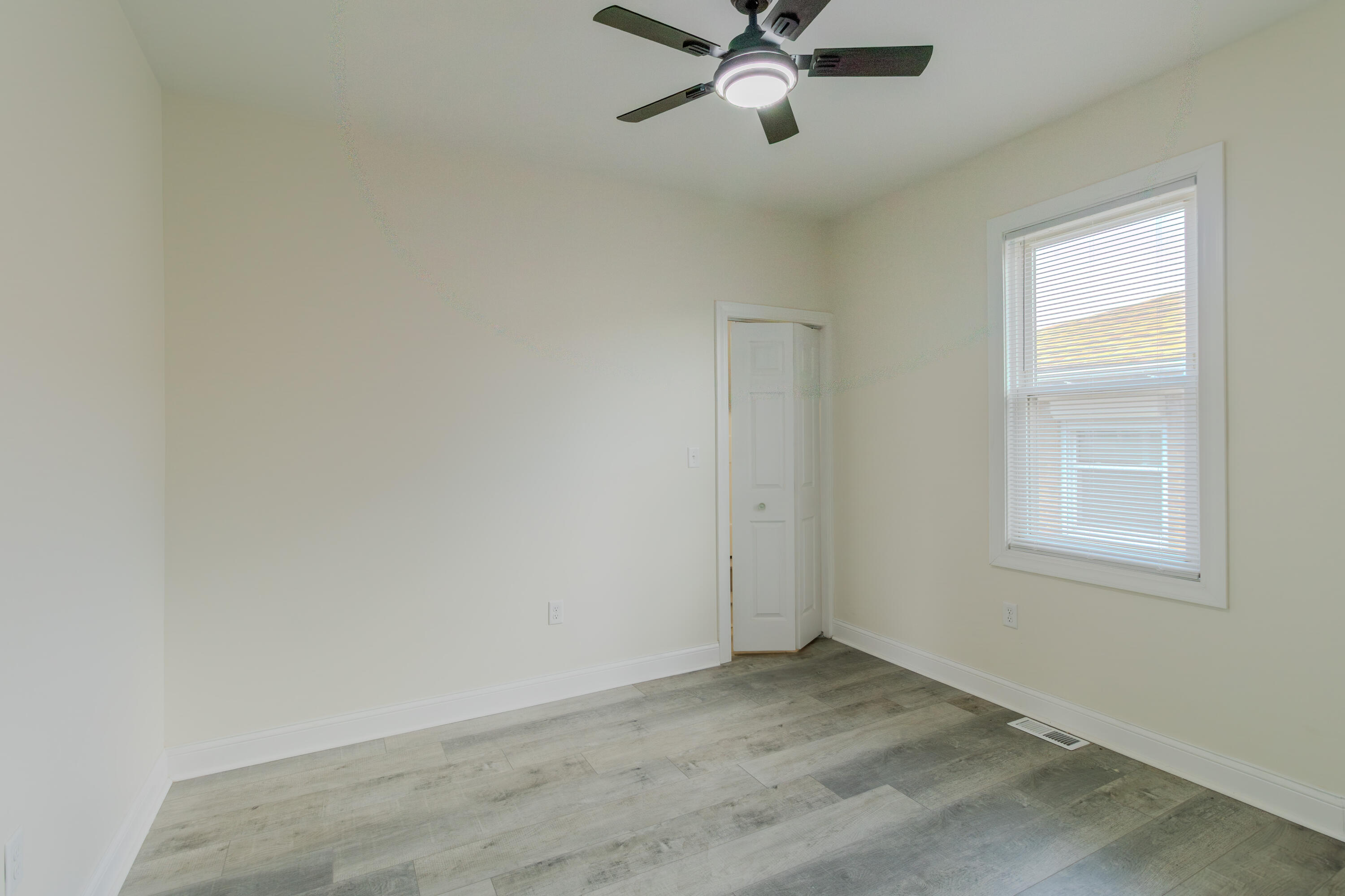 3678 Jackson Street Gary, IN 46408 - Photo 14 of 27 an empty room with windows and fan