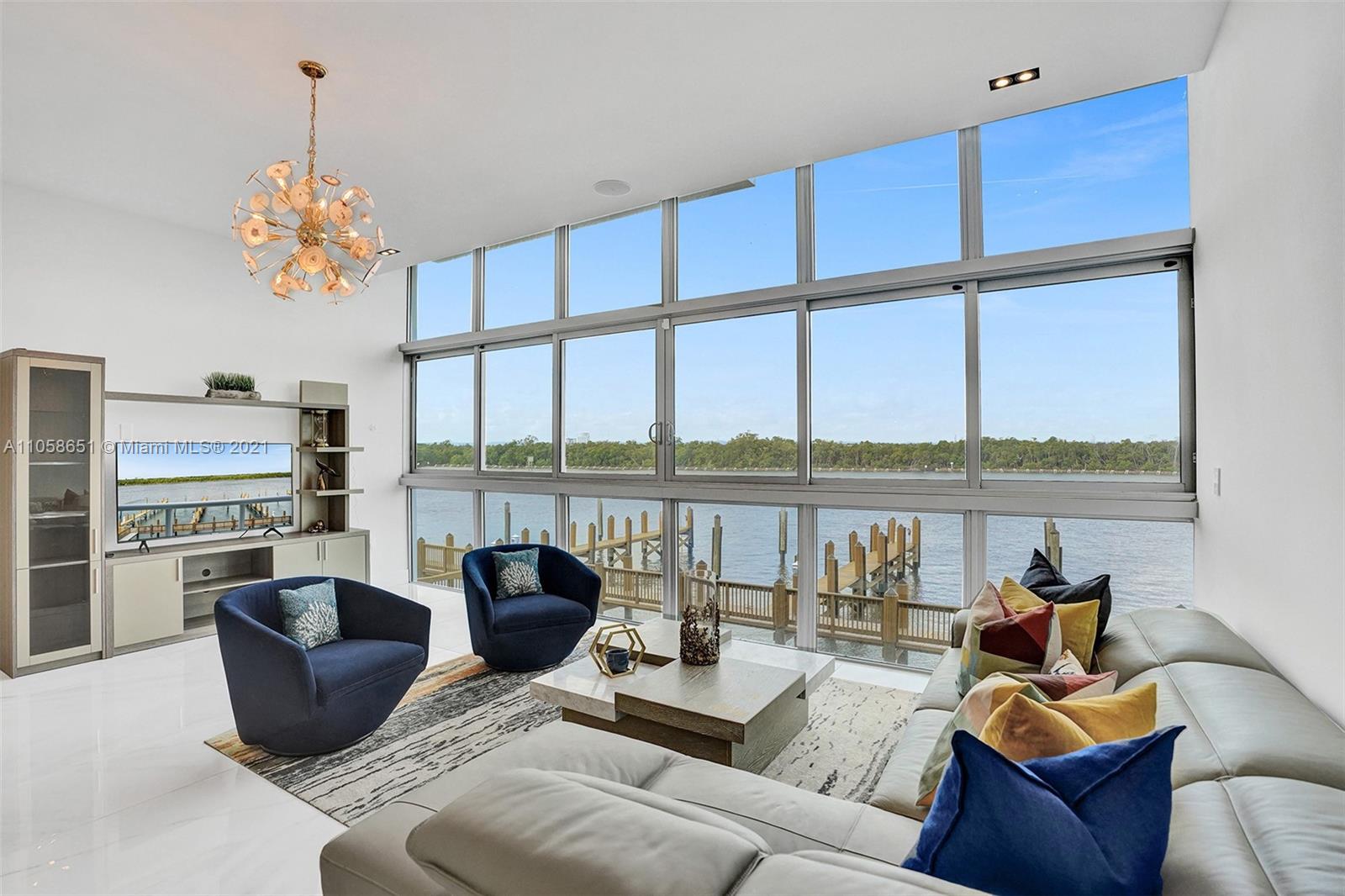 a living room with furniture fireplace and a large window