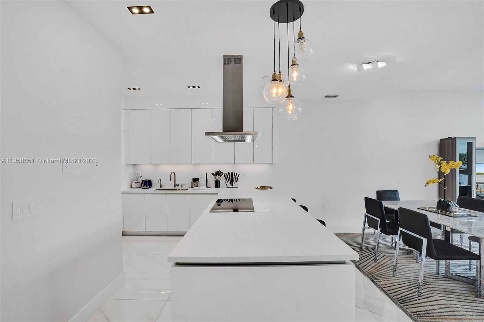 2870 North Ocean Drive Hollywood, FL 33019 - Photo 13 of 57 a kitchen with sink and white cabinets