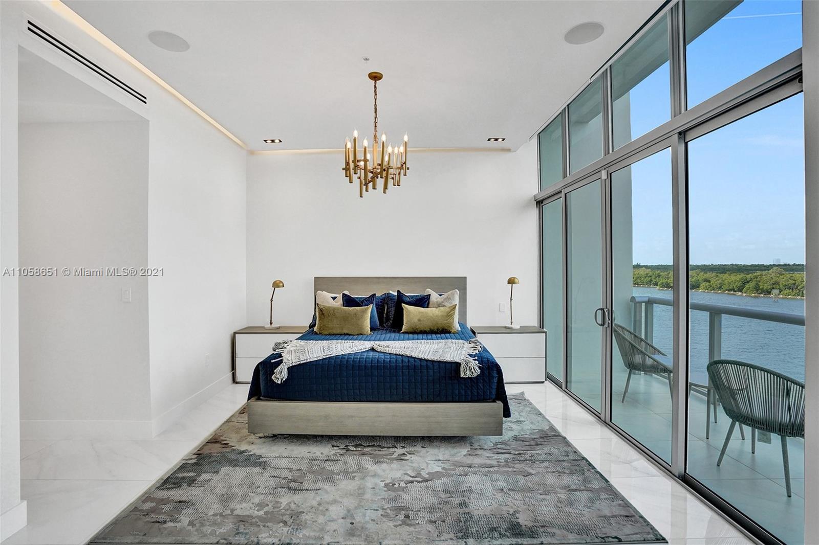 2870 North Ocean Drive Hollywood, FL 33019 - Photo 20 of 57 a spacious bedroom with a bed and a chandelier