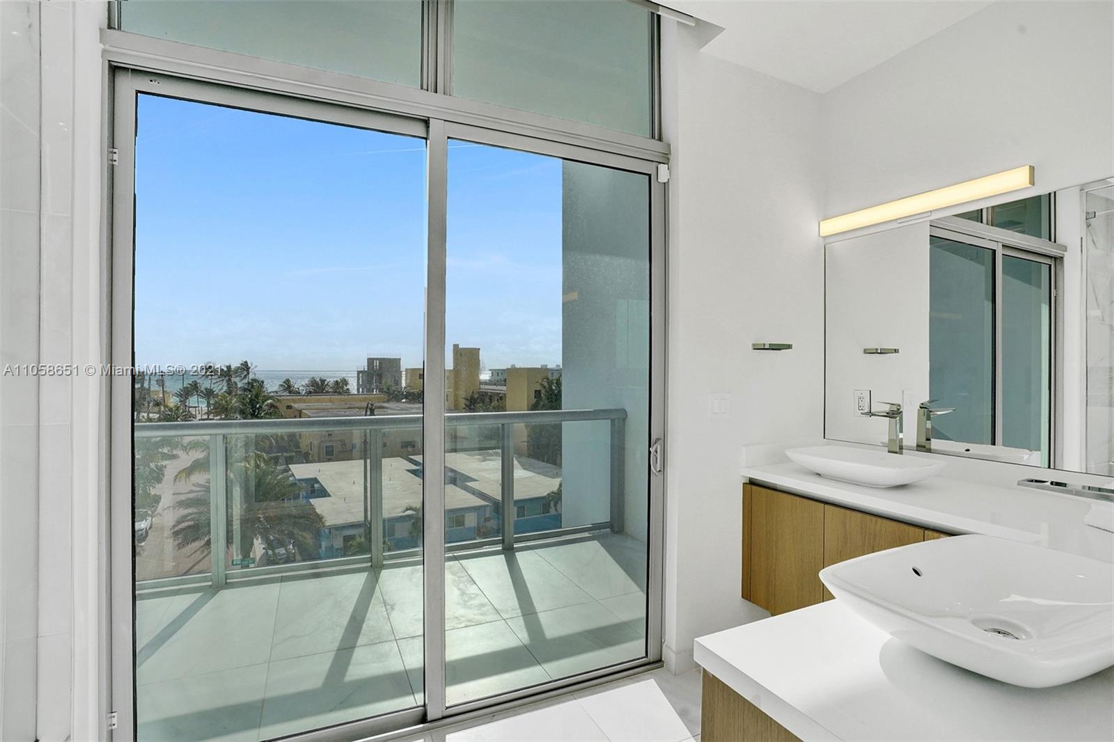 2870 North Ocean Drive Hollywood, FL 33019 - Photo 24 of 57 a bathroom with a sink and mirror