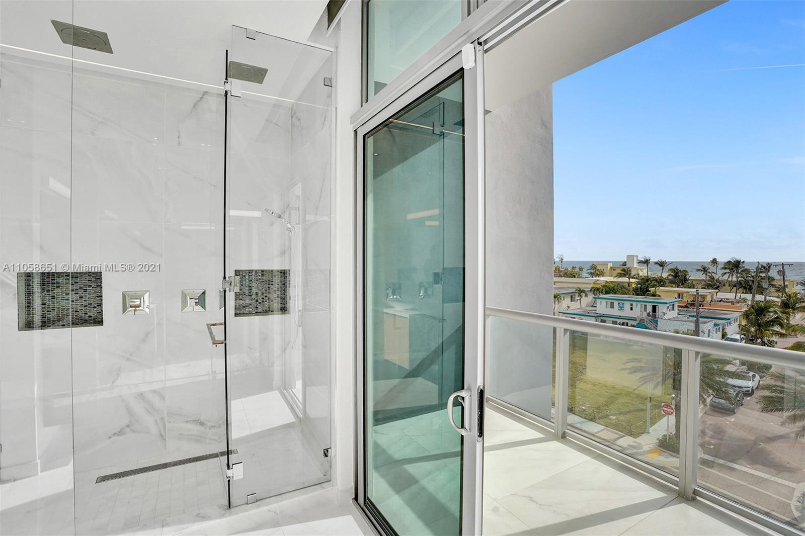 2870 North Ocean Drive Hollywood, FL 33019 - Photo 26 of 57 a bathroom with a glass shower door