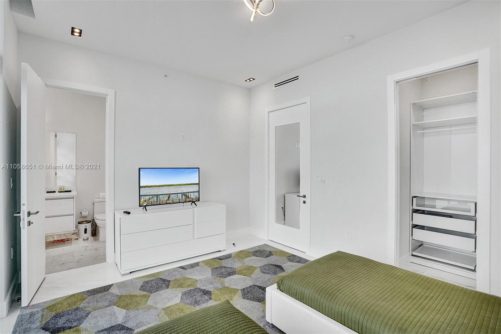 2870 North Ocean Drive Hollywood, FL 33019 - Photo 31 of 57 a bedroom with a bed and cabinets