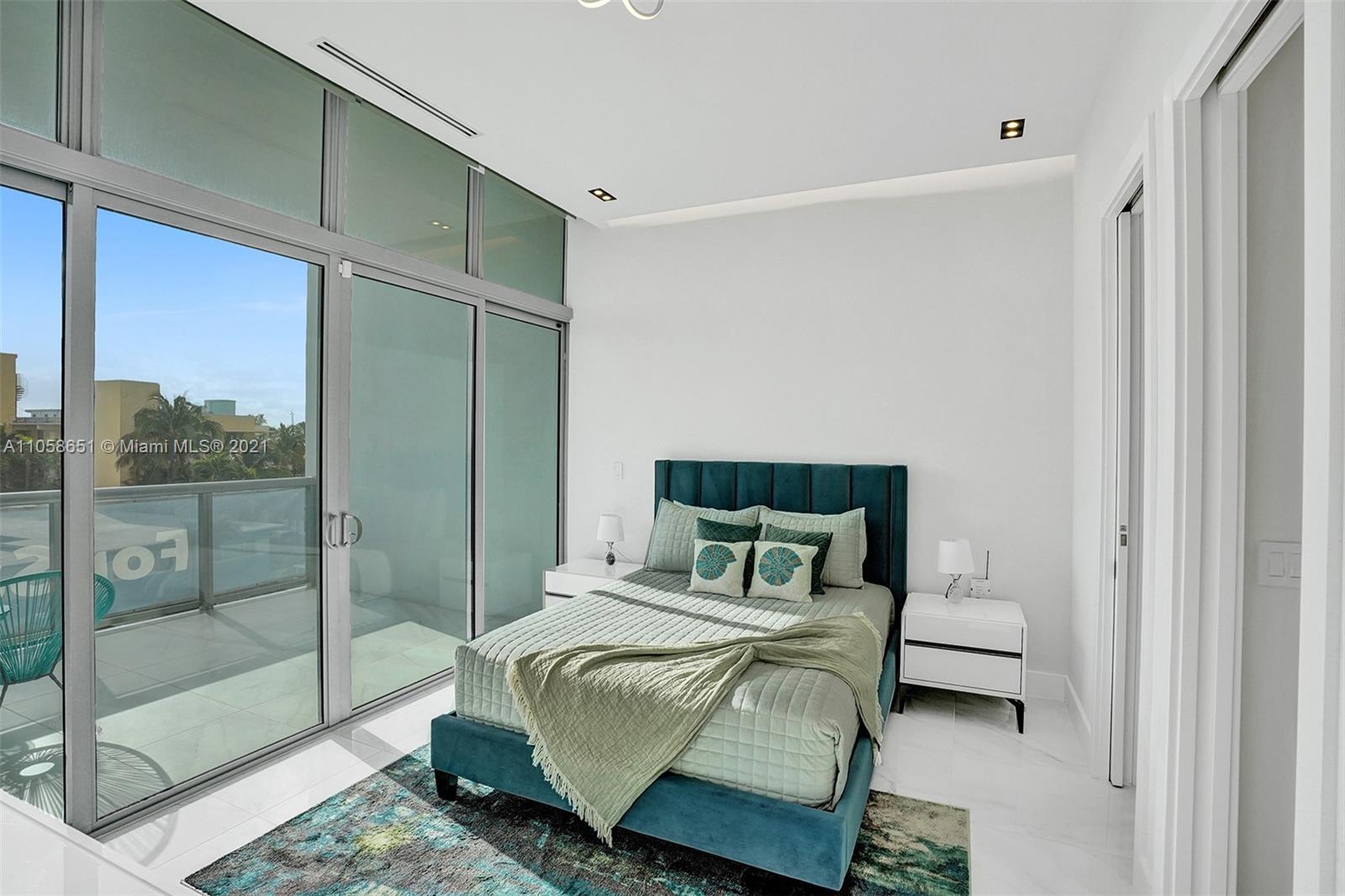 2870 North Ocean Drive Hollywood, FL 33019 - Photo 37 of 57 a bedroom with a bed and glass door