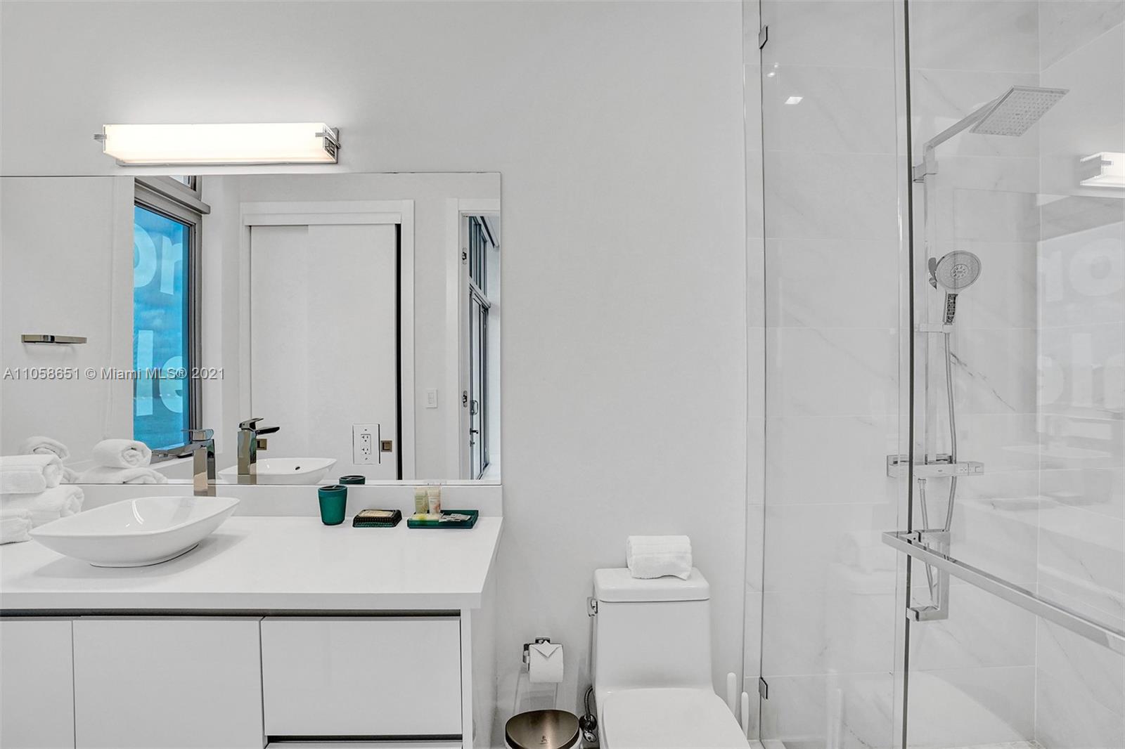 2870 North Ocean Drive Hollywood, FL 33019 - Photo 39 of 57 a bathroom with a sink toilet vanity and shower