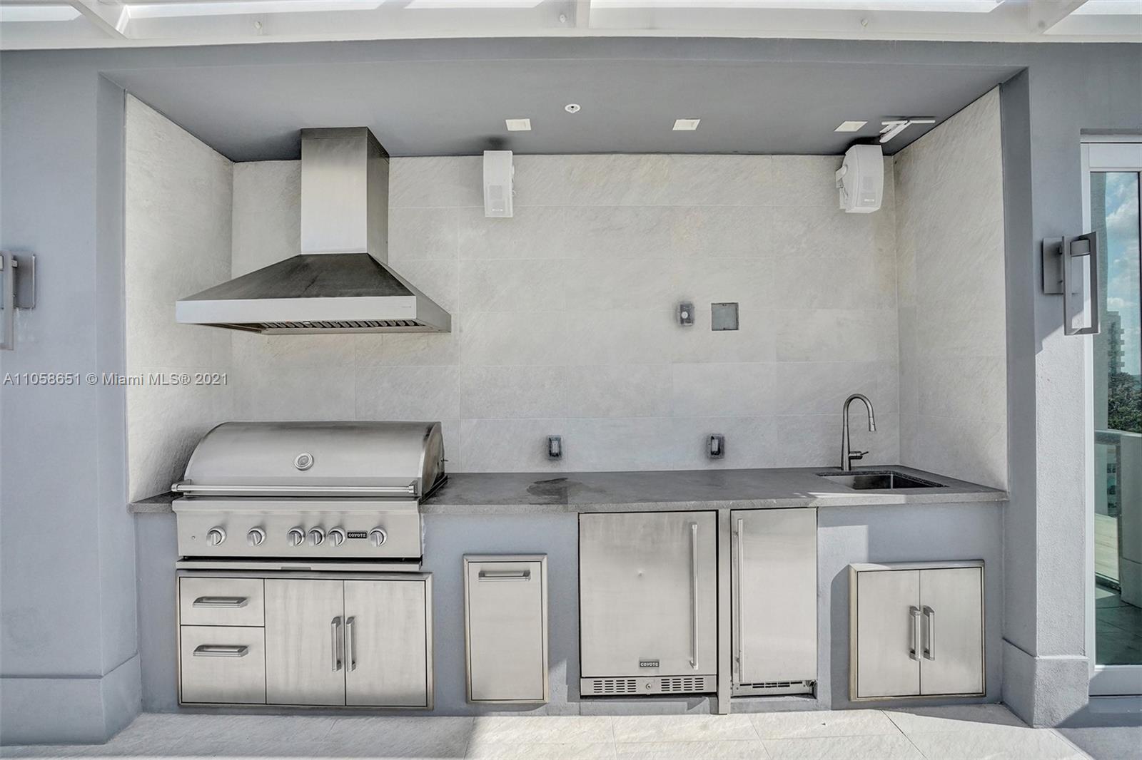 2870 North Ocean Drive Hollywood, FL 33019 - Photo 45 of 57 a kitchen with stainless steel appliances granite countertop a sink stove and cabinets