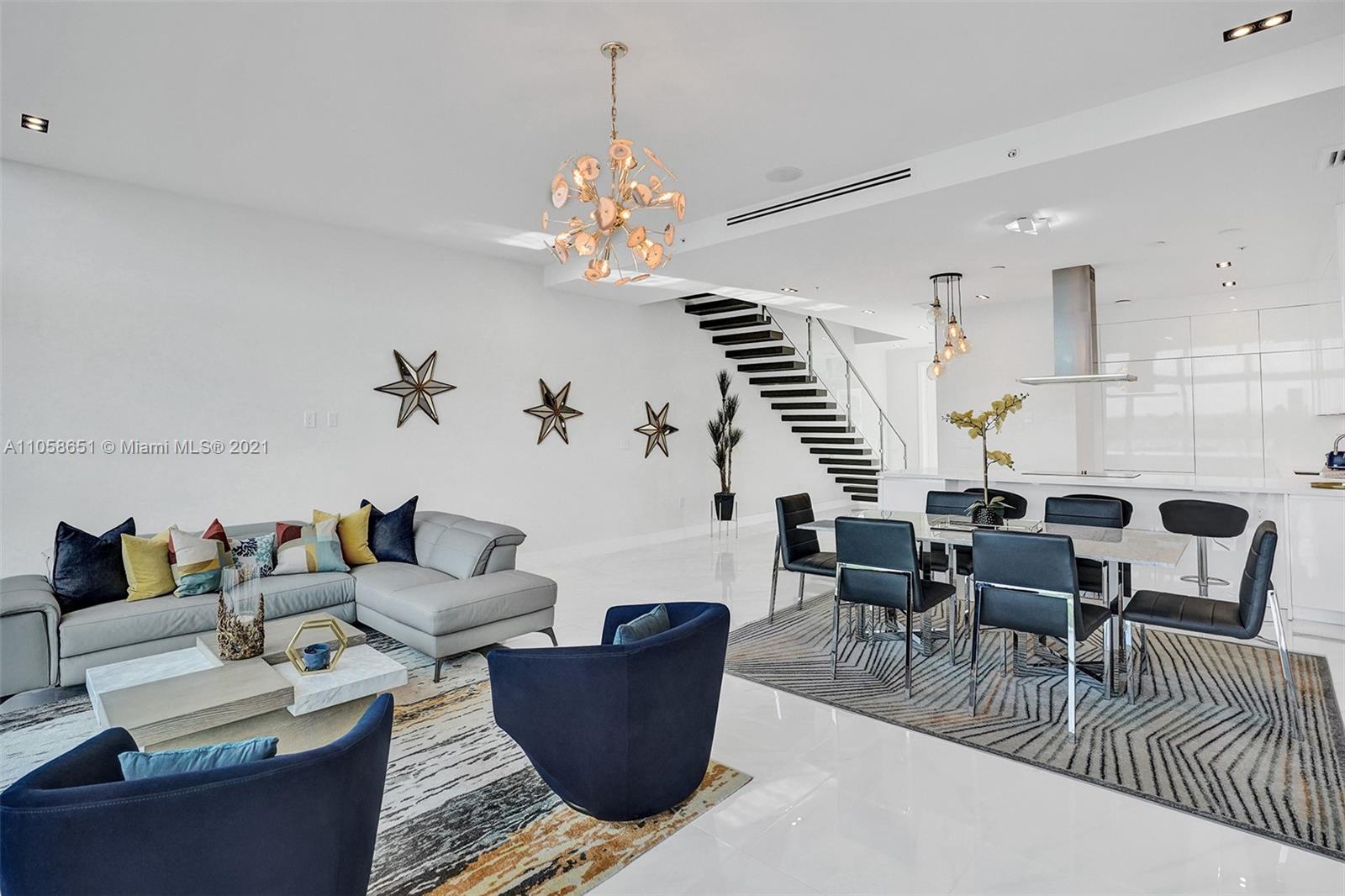 2870 North Ocean Drive Hollywood, FL 33019 - Photo 7 of 57 a living room with furniture wooden floor and chandelier