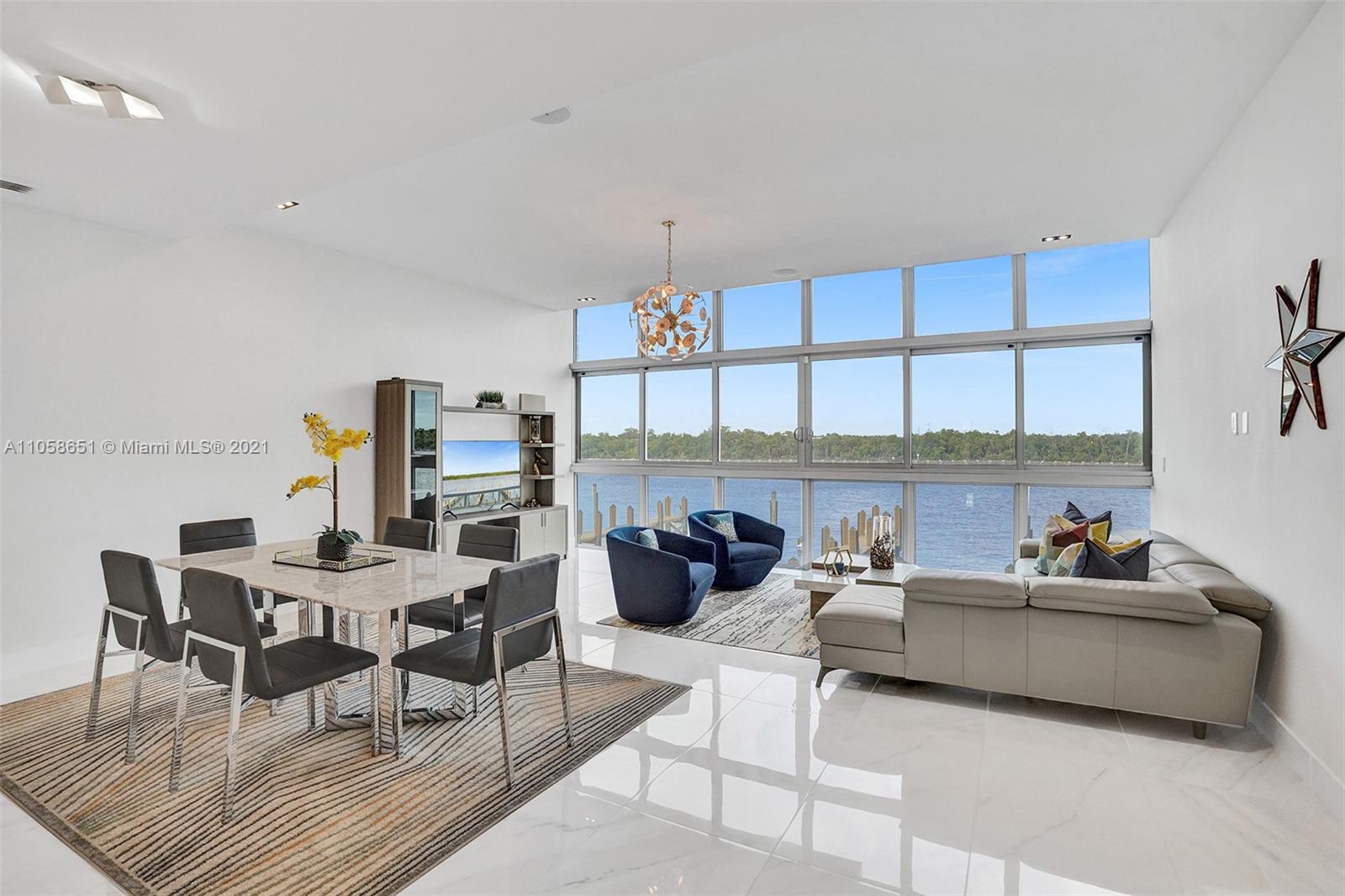 2870 North Ocean Drive Hollywood, FL 33019 - Photo 9 of 57 a living room with furniture a rug and white walls