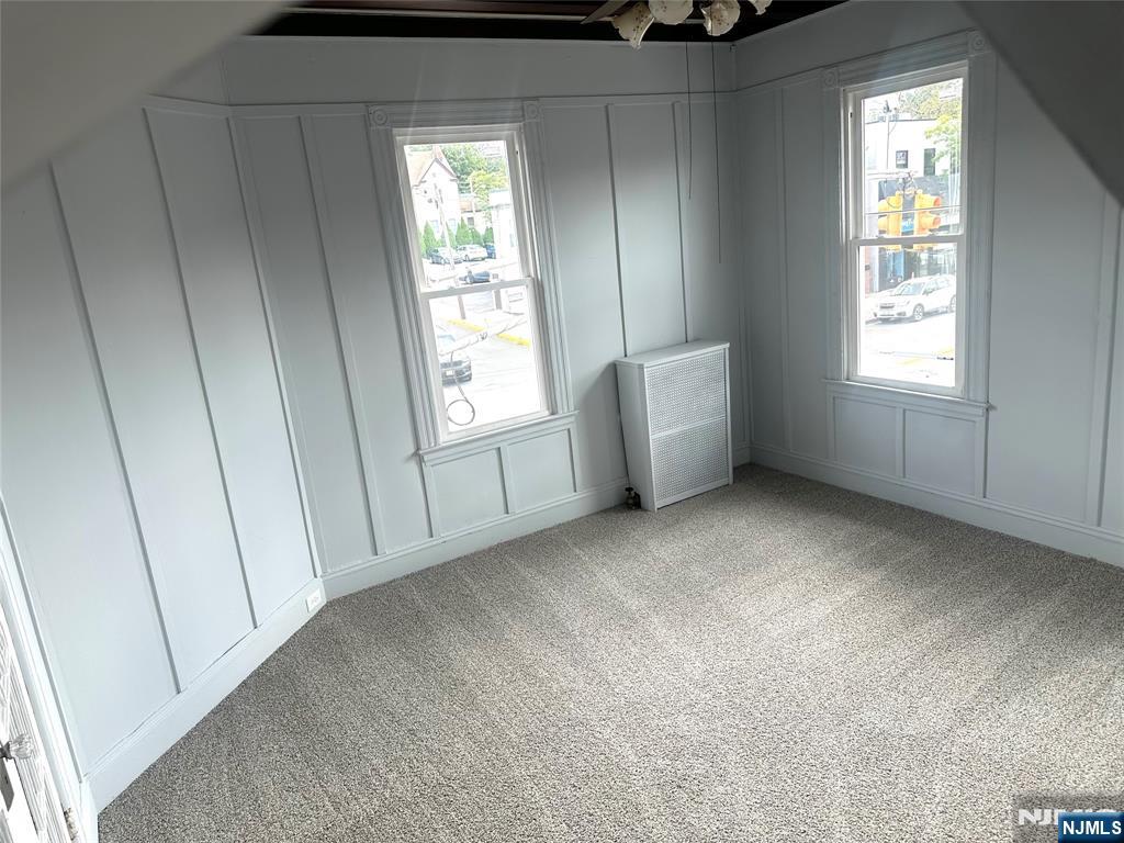 217 Boulevard, Unit 2B Hasbrouck Heights, NJ 07604 - Photo 3 of 11 an empty room with windows