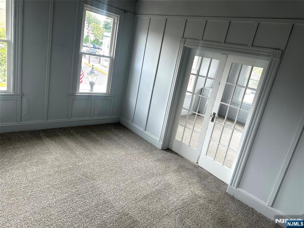 217 Boulevard, Unit 2B Hasbrouck Heights, NJ 07604 - Photo 4 of 11 an empty room with wooden floor and windows