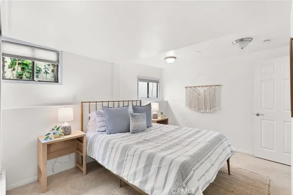a living room with furniture fireplace and a large window