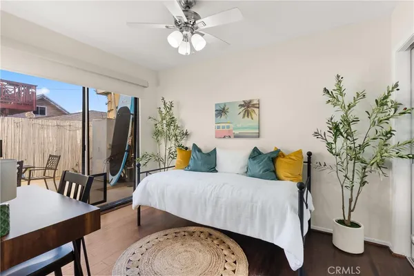 a bedroom with a large bed and a potted plant