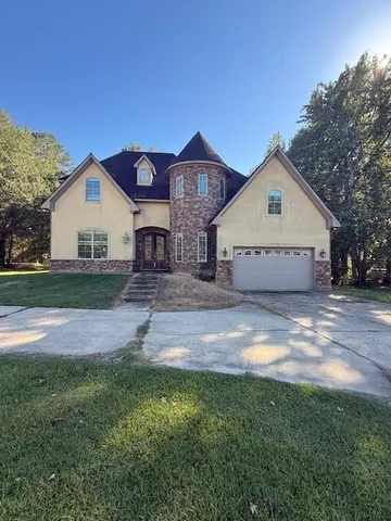 a front view of a house with a yard and garage