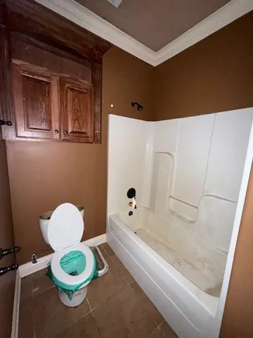 a bathroom with a toilet and a bathtub