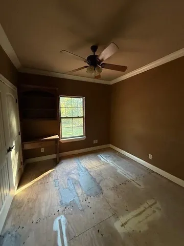 a view of a livingroom with a ceiling fan and window
