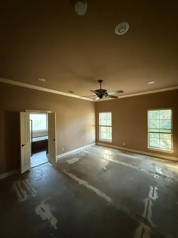 a view of a livingroom with a ceiling fan and window