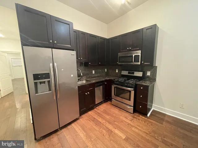 a kitchen with stainless steel appliances wooden cabinets and granite counter tops