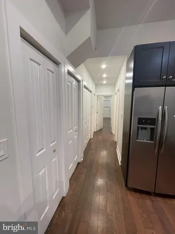 a view of a refrigerator in kitchen and wooden floor
