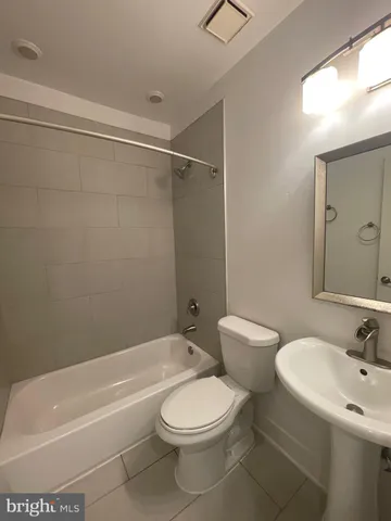 a bathroom with a toilet sink and shower
