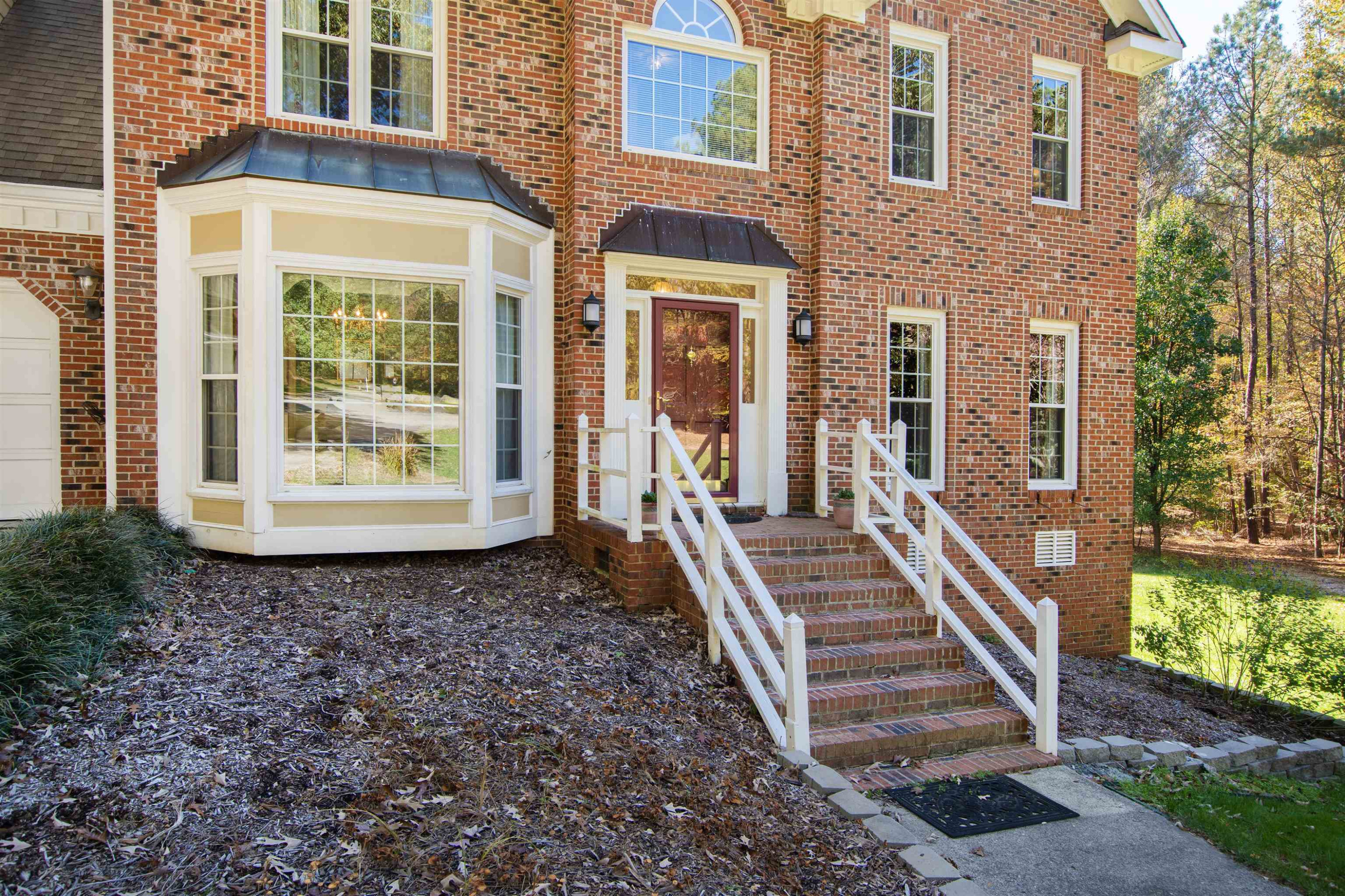 6404 Olivula Terrace Raleigh, NC 27613 - Photo 4 of 49 a front view of a house with a yard