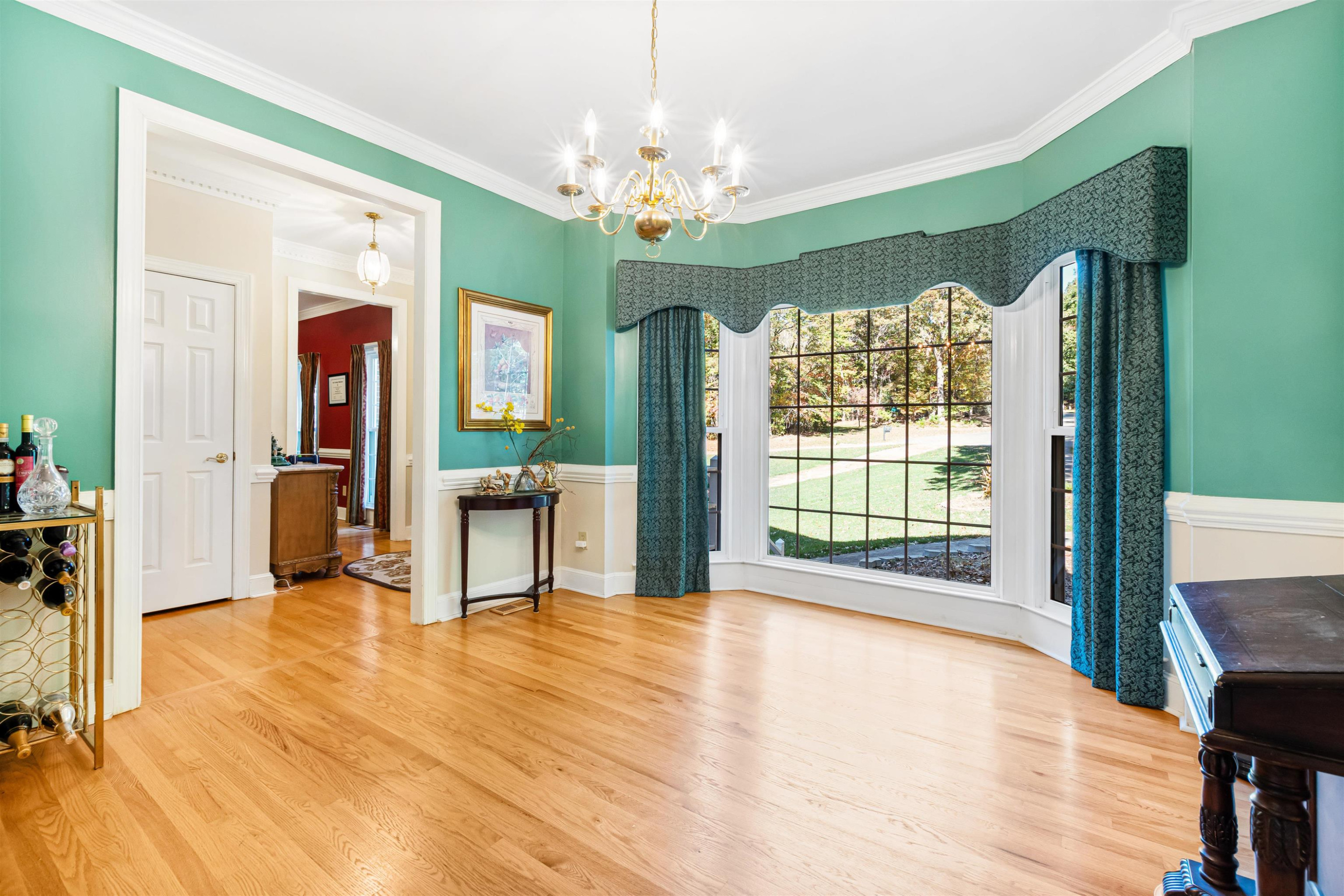 6404 Olivula Terrace Raleigh, NC 27613 - Photo 8 of 49 a view of an empty room with a window and wooden floor