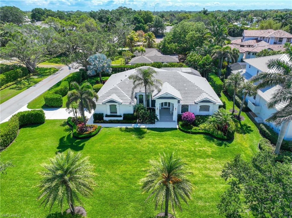 a aerial view of a house with yard and green space