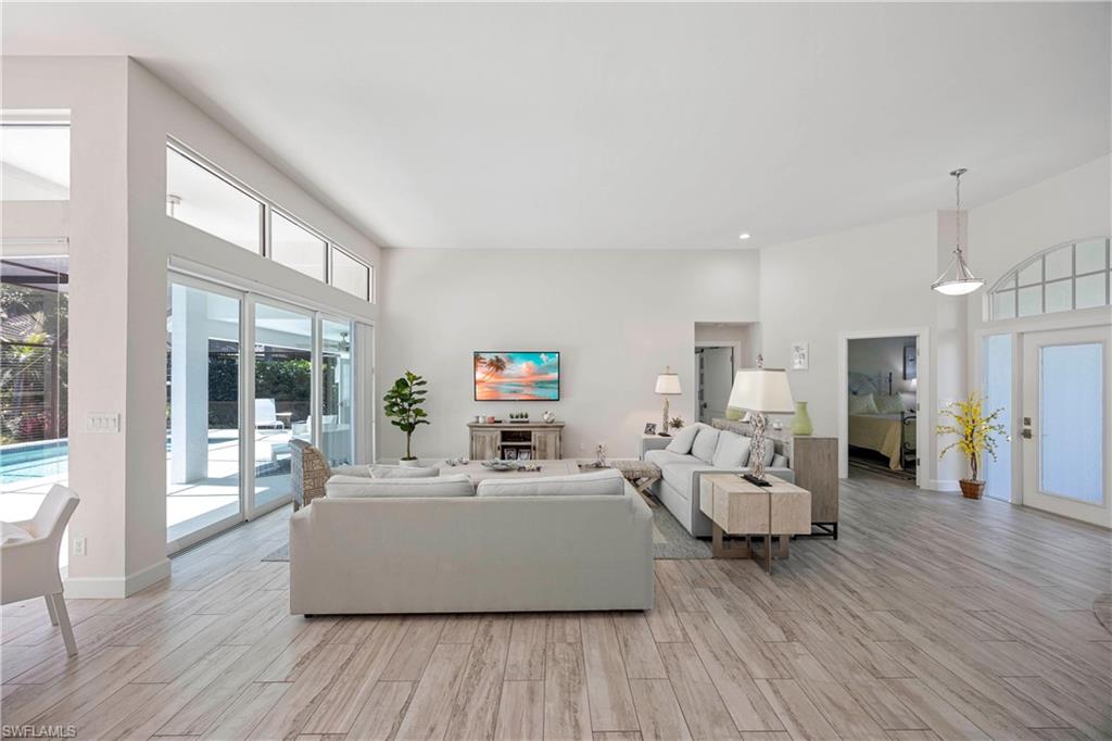1850 Crayton Road Naples, FL 34102 - Photo 11 of 48 a living room with furniture and a large window