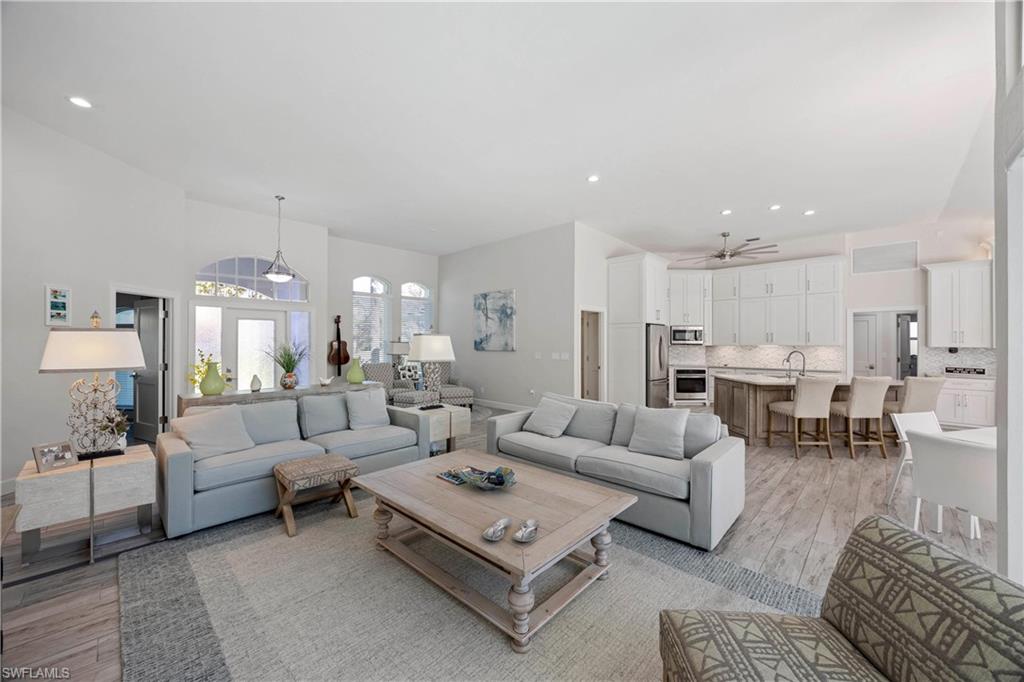 1850 Crayton Road Naples, FL 34102 - Photo 13 of 48 a living room with furniture kitchen view and a table