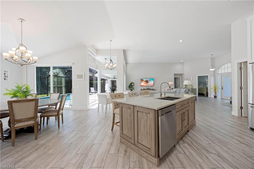 1850 Crayton Road Naples, FL 34102 - Photo 48 of 48 a open kitchen with stainless steel appliances granite countertop a kitchen island a stove a table and chairs in it