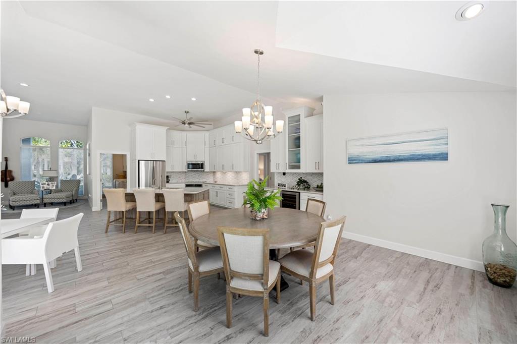 1850 Crayton Road Naples, FL 34102 - Photo 18 of 48 a view of a dining room with furniture and wooden floor
