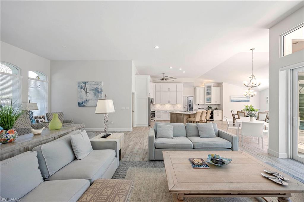 1850 Crayton Road Naples, FL 34102 - Photo 20 of 48 a living room with furniture wooden floor and a large window