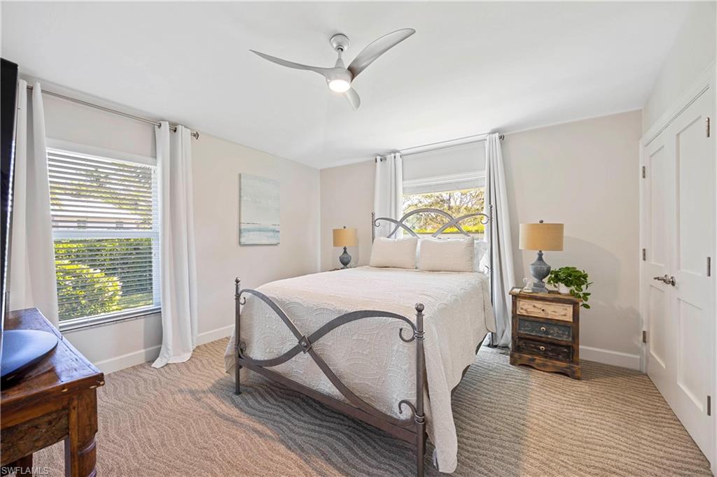 1850 Crayton Road Naples, FL 34102 - Photo 29 of 48 a bedroom with a bed and wooden floor