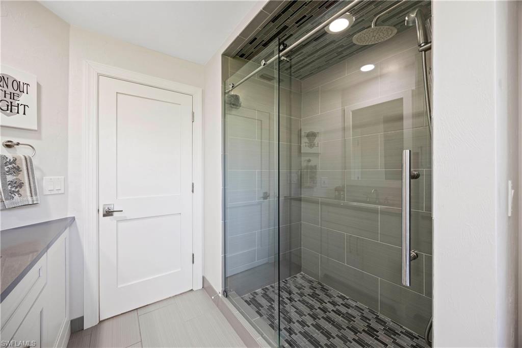 1850 Crayton Road Naples, FL 34102 - Photo 31 of 48 a bathroom with a shower and a sink