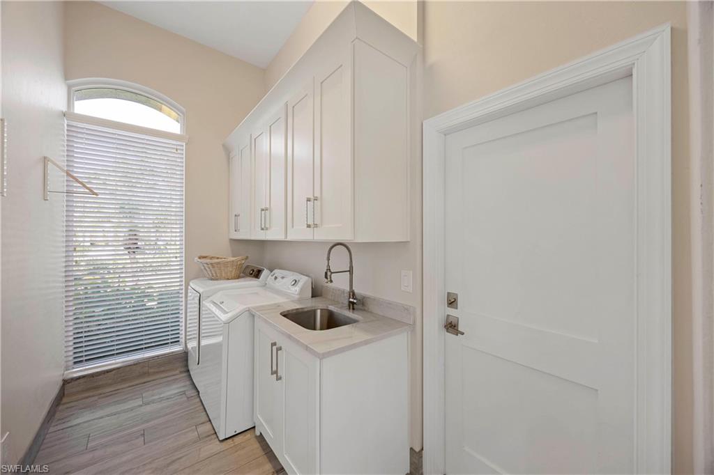 1850 Crayton Road Naples, FL 34102 - Photo 32 of 48 a kitchen with a sink a stove and cabinets