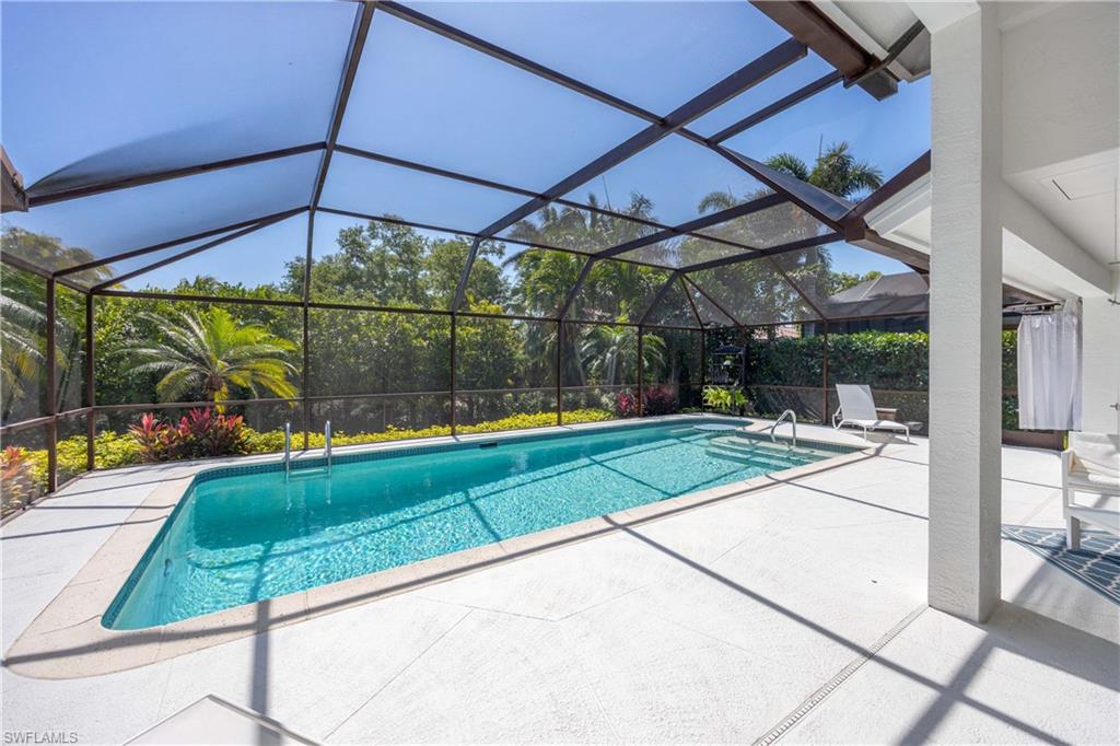 1850 Crayton Road Naples, FL 34102 - Photo 33 of 48 a view of a backyard with a small deck and a garden