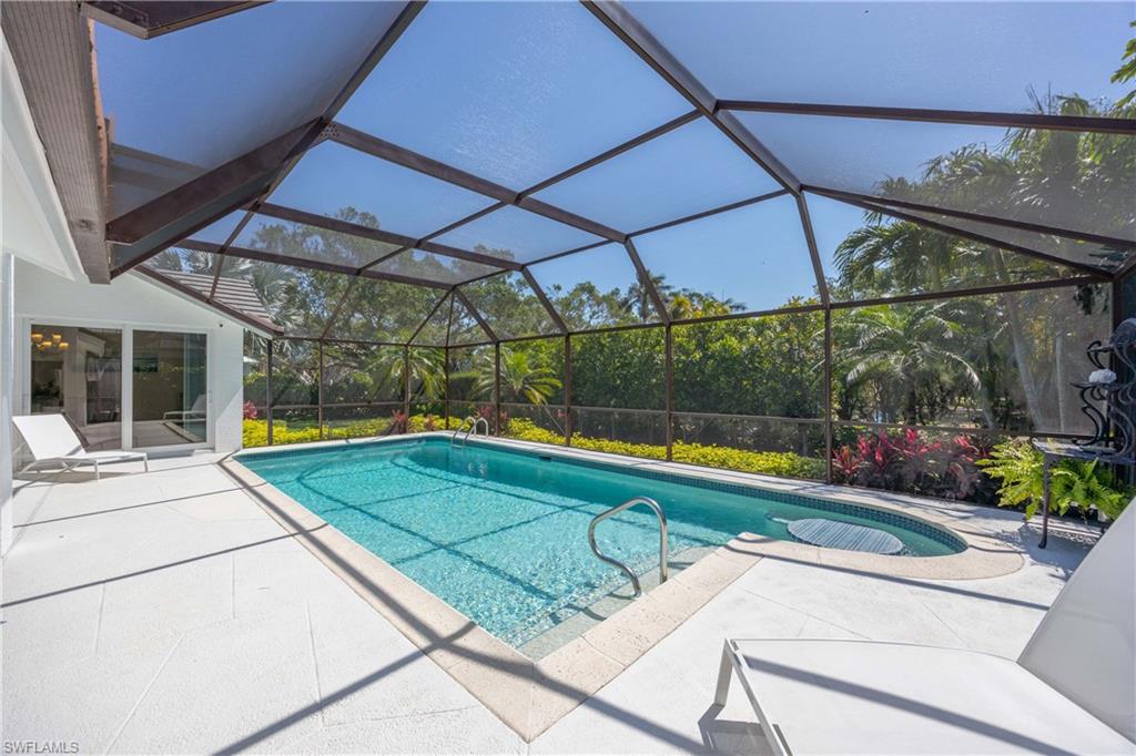1850 Crayton Road Naples, FL 34102 - Photo 34 of 48 a view of a backyard with swimming pool and sitting area