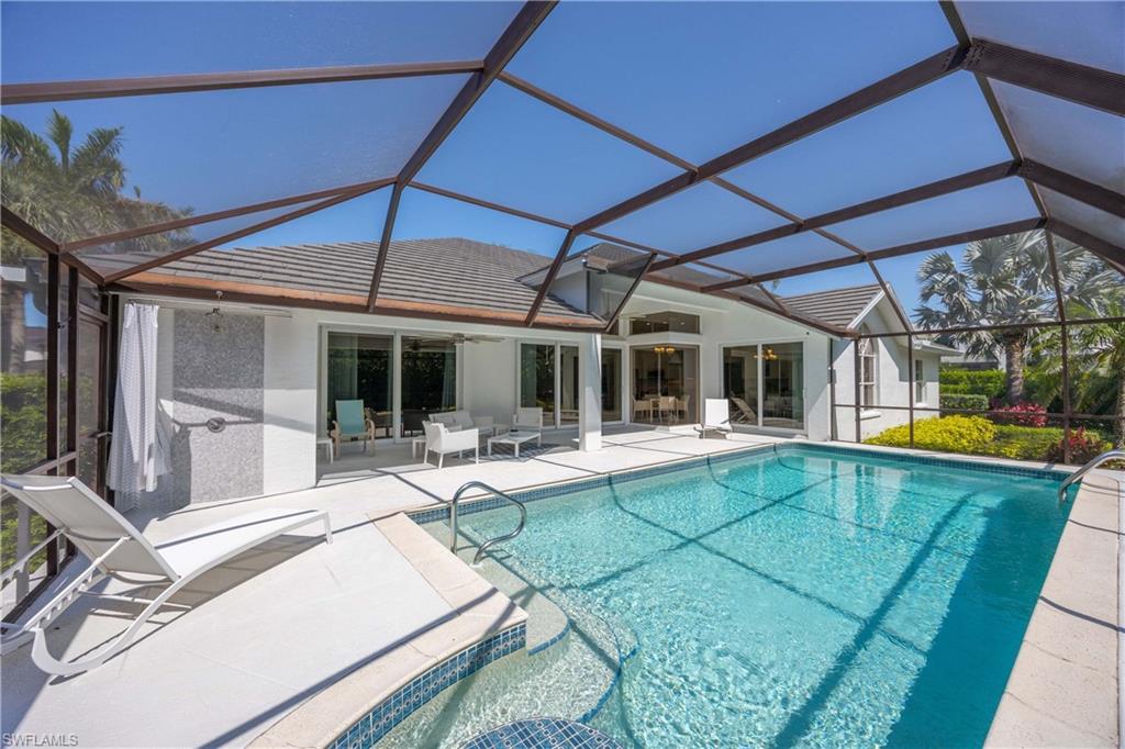 1850 Crayton Road Naples, FL 34102 - Photo 37 of 48 a view of a house with backyard sitting area and porch